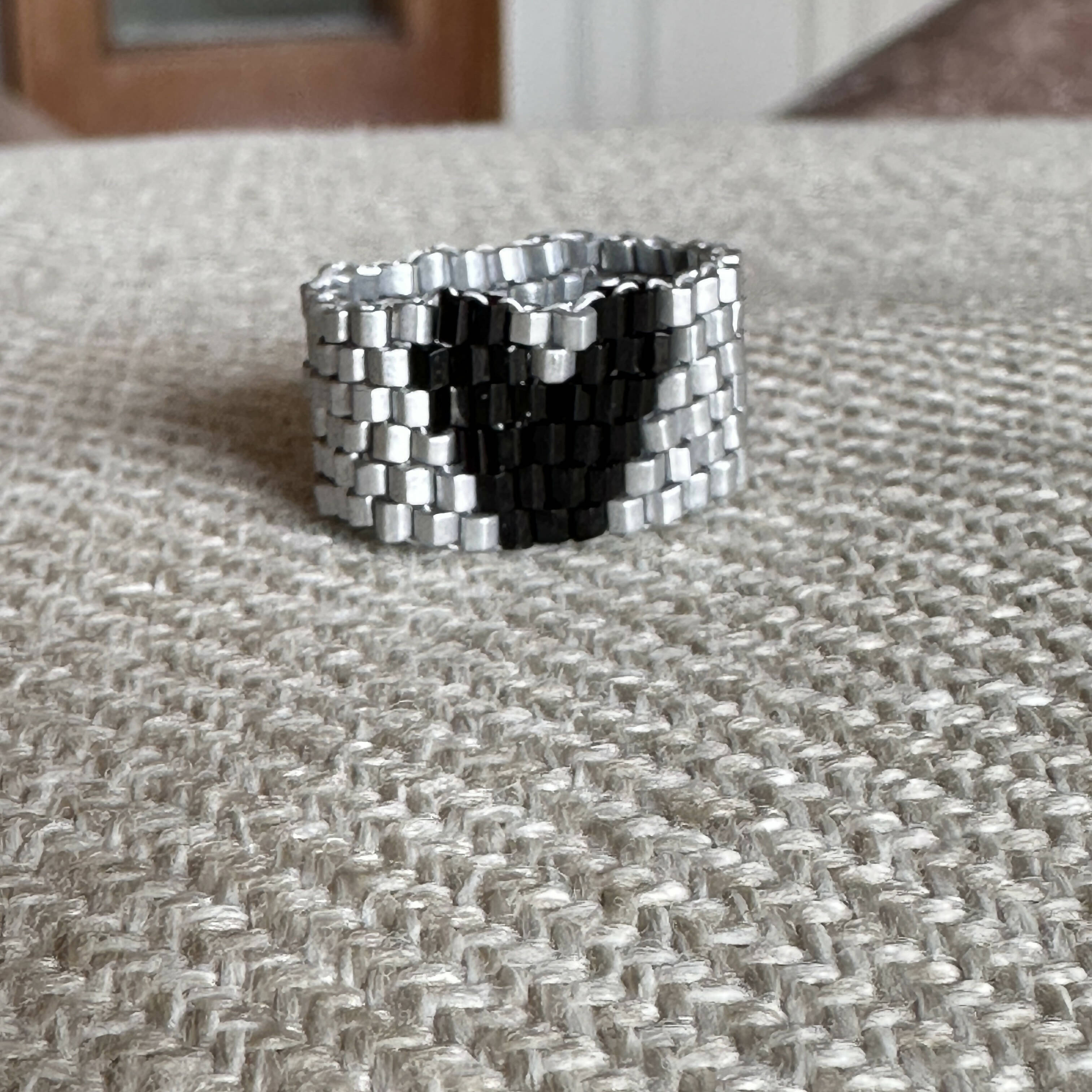 The PUT A RING ON IT collection: Black heart on silver, 6 rows!