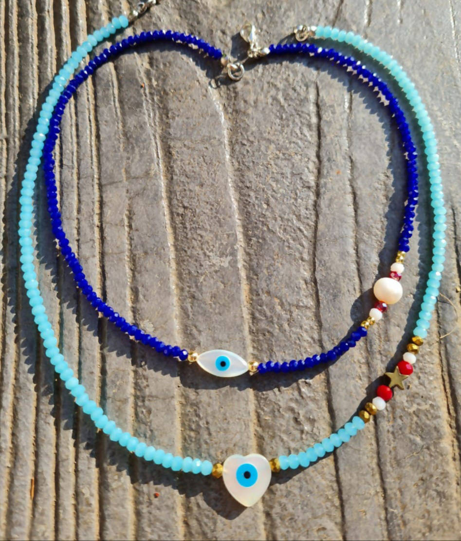 Crystal light blue with mother of pearl heart evil eye